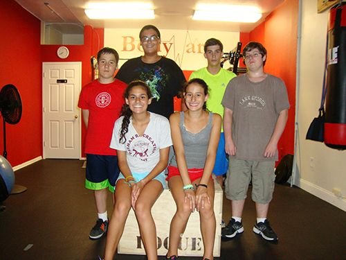 Image of a group of teens surrounding a plyometric box